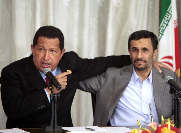 Venezuela's President Chavez speaks next to Iran's President Ahmadinejad during an agreement-signing ceremony in Tehran